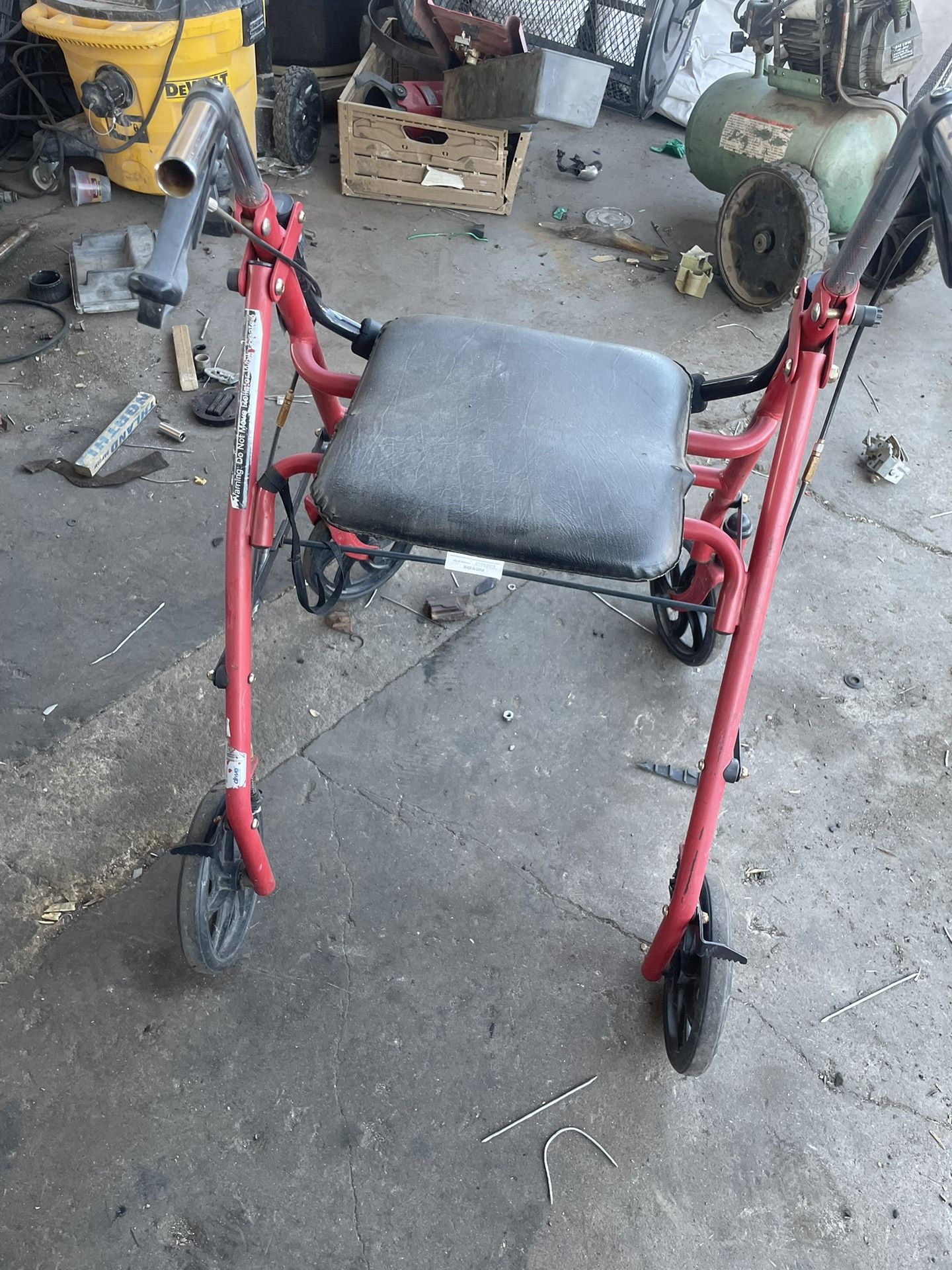 red Drive Medical 4-Wheel Rollator walker with a seat.