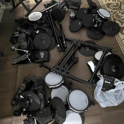 Mixed electronic drum kit bundle includes components from Roland, Simmons, and RockJam. Set has various mesh and rubber drum pads, cymbal pads, $450 O