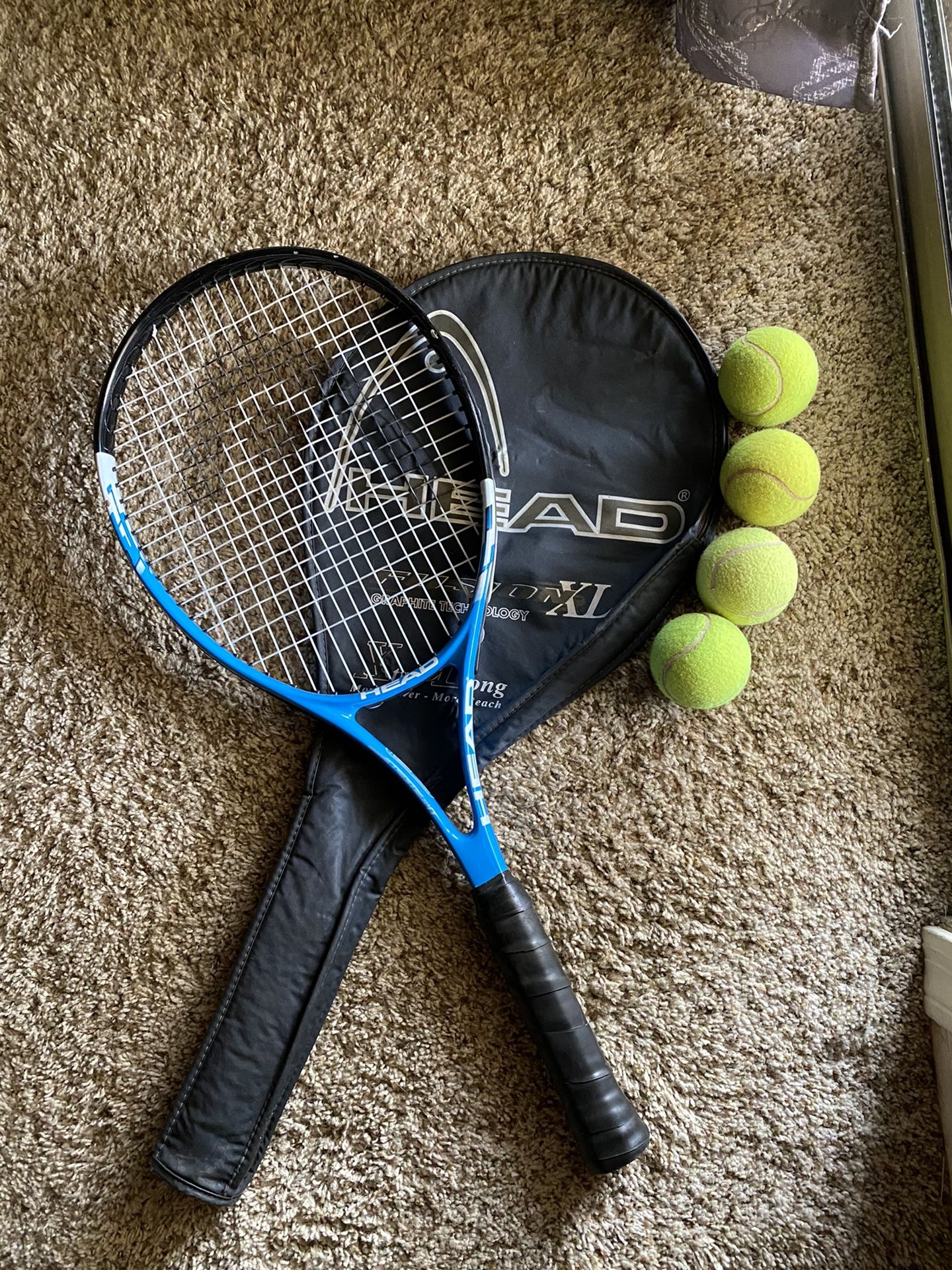 Tennis racket with balls