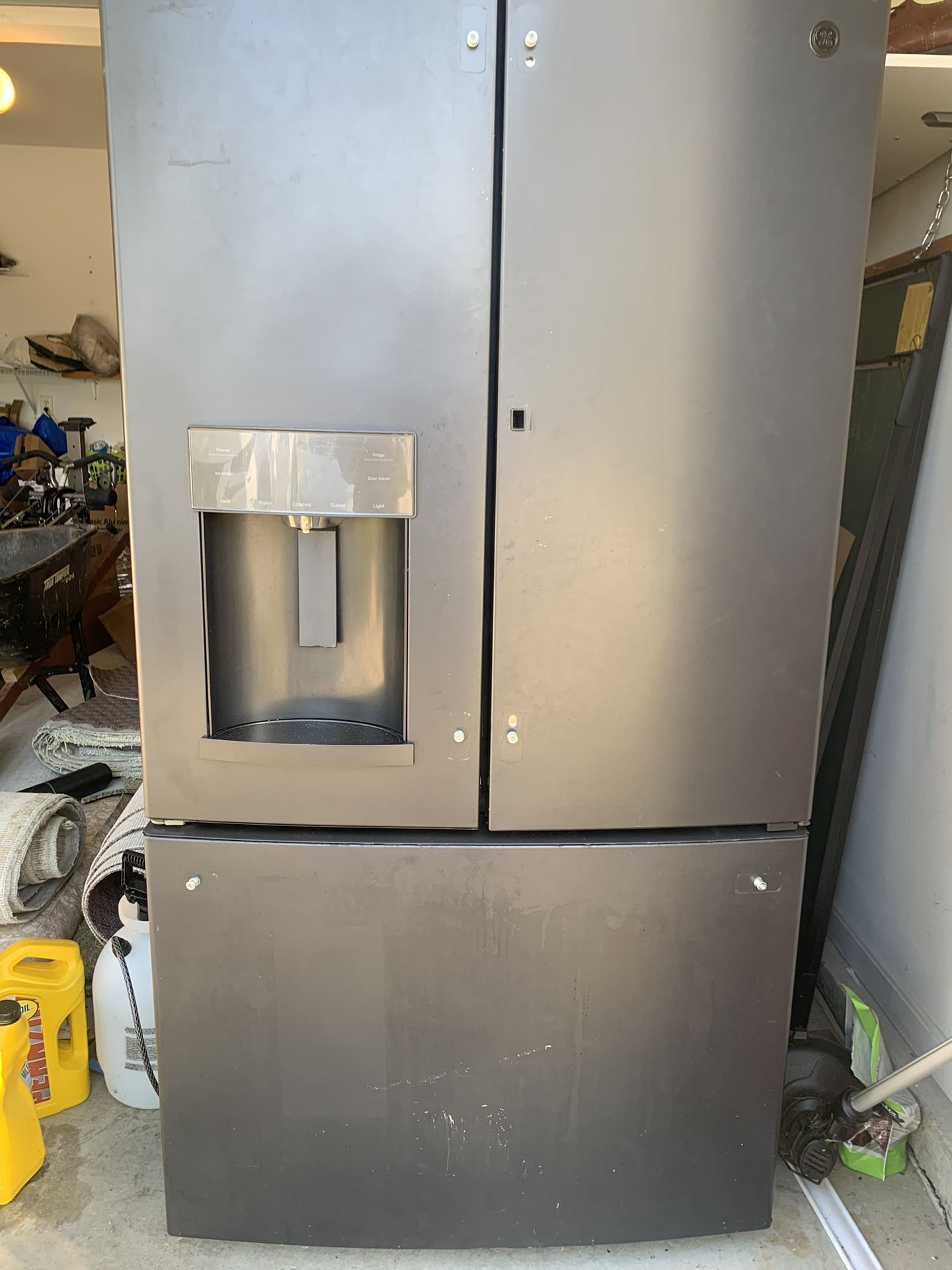 Black GE refrigerator with built-in water dispenser. Freezer works fine. Refrigerator needs air/ gas to cool at 100%.