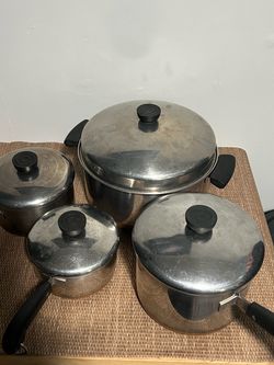 4 pan set of Revere pans with lids.
