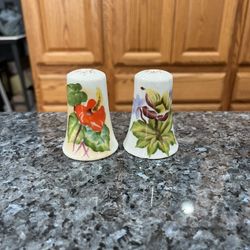 Vintage Ceramic Hand Painted floral pair of salt and pepper shakers.  Preowned missing stoppers.  Has been on display in a cabinet with a very large s