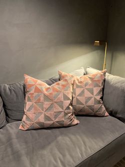 Pink and gray down-filled pillows