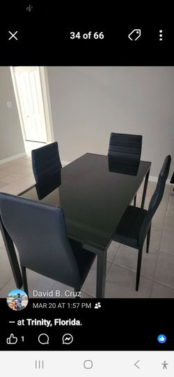 Table with 4 black chairs