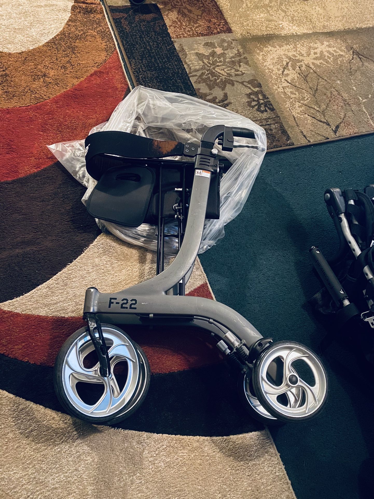 $125-Foldable senior Walking apparatus with Seat and Four big Wheels- (well loved as you can see as it has some discoloration from use on back b