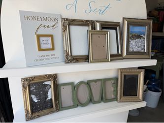 Bundle of gold tone picture frames, and honeymoon fund sign