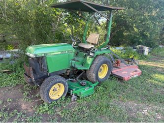 John Deere subcompact Tractor with belly mower and shredder