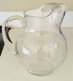 Glass rounded pitcher, 9” tall, 8” wide.