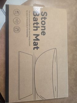 Stone bath mat.  White marbled