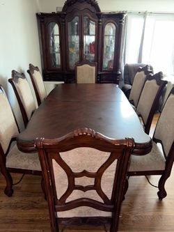 Dining table with 8 chairs and its showcase