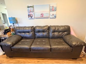 Dark grey faux leather tufted sofa bed