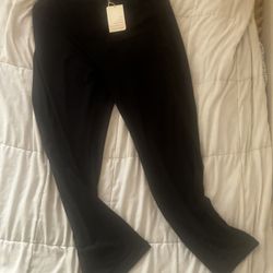 Professional flared silhouette with a zip-fly and button closure.