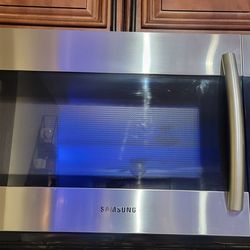 Stainless Samsung Microwave - Needs door repair $100