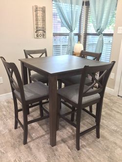 Brand new counter height dining table with 4 chairs