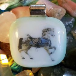 A CAROUSEL HORSE FUSED GLASS PENDANT 