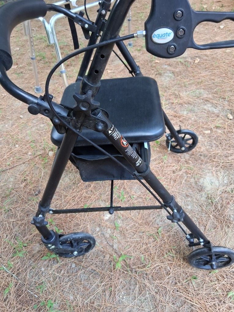 USED EQUATE WALKER W/ CHAIR & POUCH
