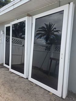 Brand New 93.25W x 90.5H PGT Impact Vinyl Sliding Door with Frame and Handles.