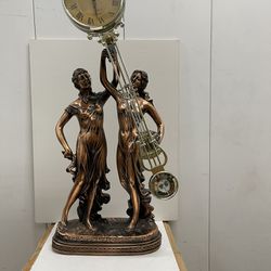 swinging statue clock with musician