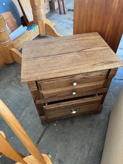 Brown Wood Three-Drawer Nightstand with Ornate Hardware