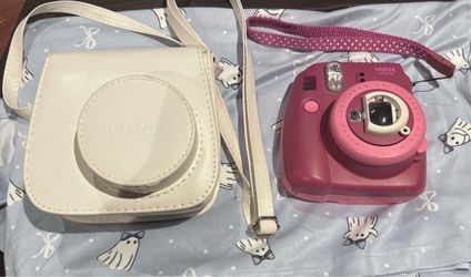 Purple Fujifilm Instax Mini 9 instant camera neatly tucked inside a custom-fit white leatherette.