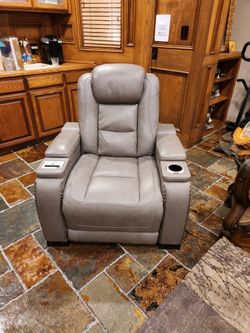 Leather Power Recliner with Adjustable Head, Cup Holder And Charging Station.