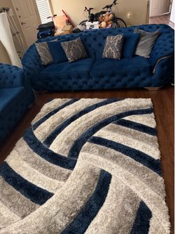 Blue velvet sofa and rug