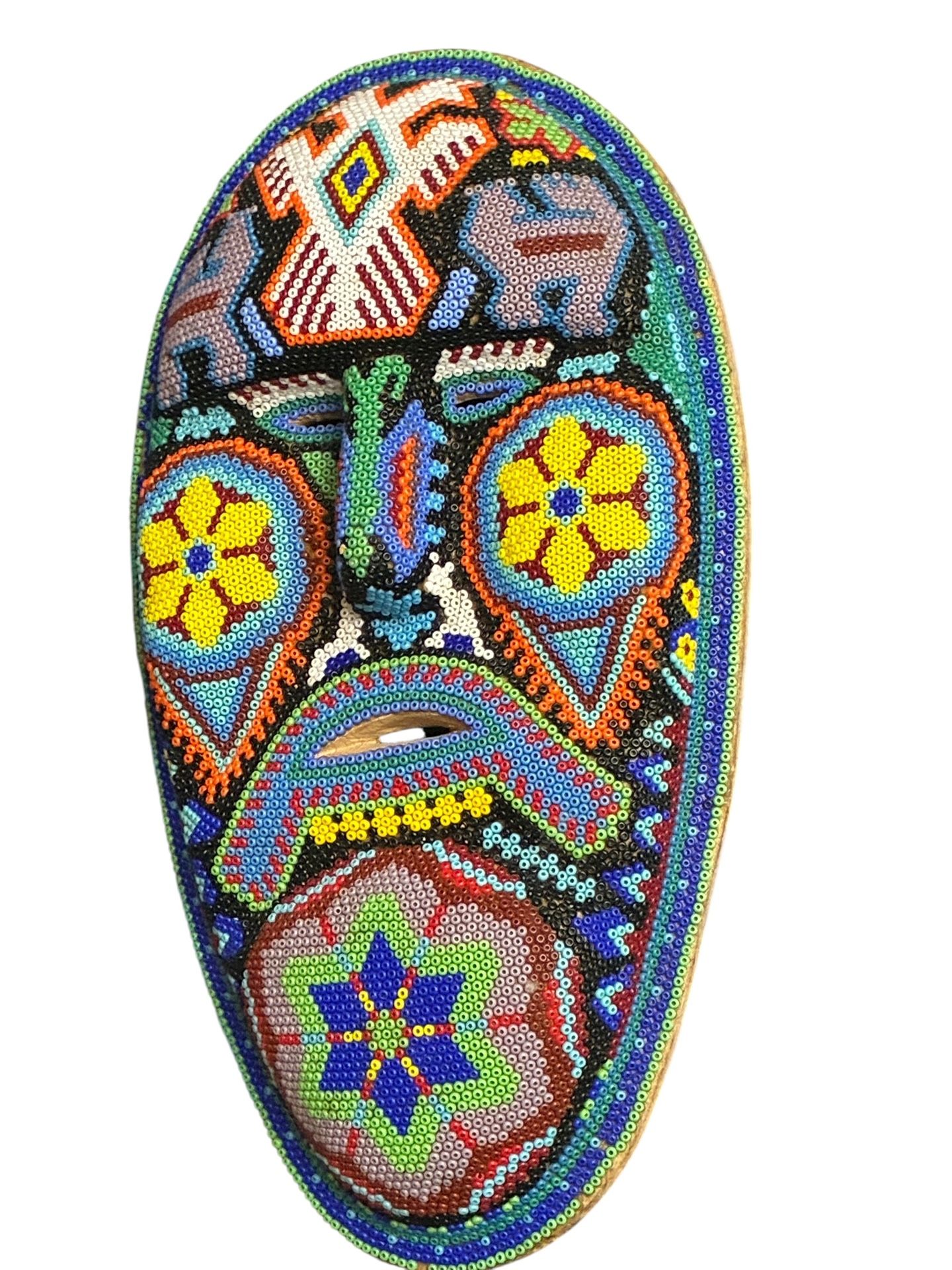 Description: Authentic Huichol (Wixárika) beaded mask, approx. 10 inches tall. Hand-carved wood base with beeswax and thousands of colorful glass seed