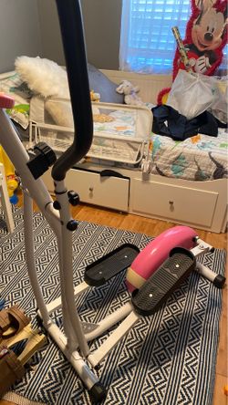 Pink and white elliptical machine
