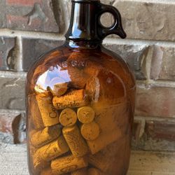 VINTAGE BROWN AMBER GLASS DURAGLASS 1 GALLON JUG W/ FINGER HANDLE (filled with wine corks) 