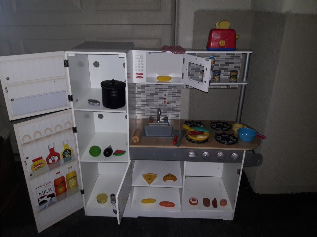 Wooden play kitchen missing a door