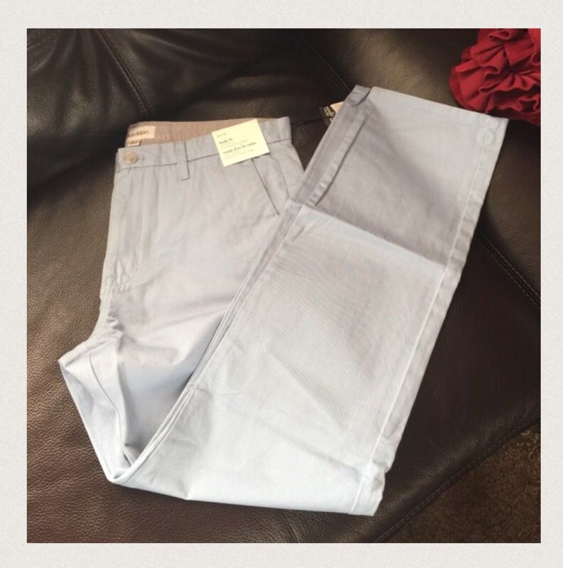 NWT Calvin Klein body fit men's pants, size 33x32, 32x32 available, sits on the hip, slim through hip and thigh, 100% cotton, color is baby blue