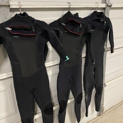 Women’s wetsuits and surfboard