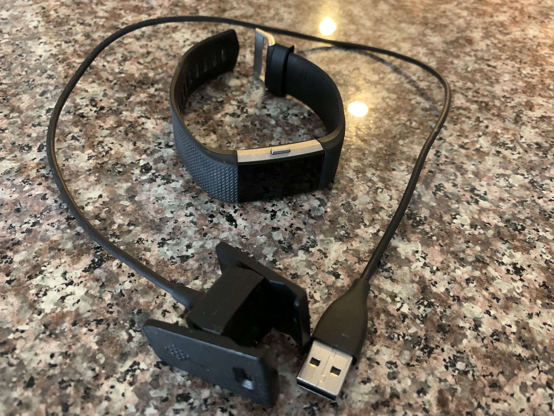 Fitbit Charge 2 Watch and charger cable in color black. Great work out watch. Great to track calories burned, miles, heart rate & time. Just downloa