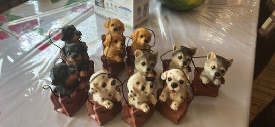 Dog out of a bag statues