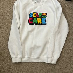 White Sweatshirt with Colorful 'Self Care' Graphic