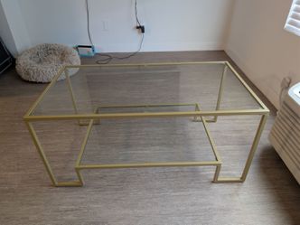 Glass top gold coffee table
