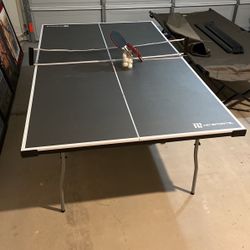 Ping Pong Table With Paddles And Jar Of Balls