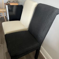 6 Black Chairs With White Cover 