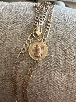 14K Yellow Gold Figaro chain with a 14k Virgin Mary pendant