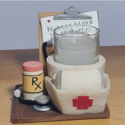 Vintage Spoontiques nurse votive holder 
candle has a scratch in it 