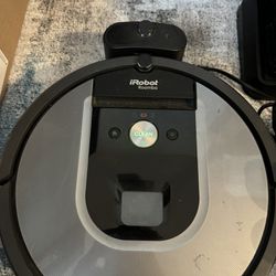 IRobot Roomba vaccum and charging station  Vacuum is missing the plastic attachments and one of the inserts for them - see pictures 