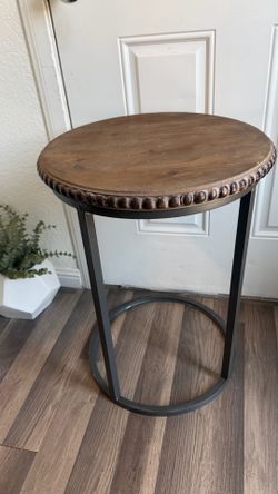 C-Shaped Table — Round natural wood top with a beaded edge and metal frame