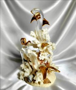 Melanie Cech glass sculpture featuring dolphins with 22K gold accents mounted
