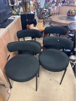 black Living Spaces modern boucle fabric dining chair features a curved backrest and slender black legs - $25 each