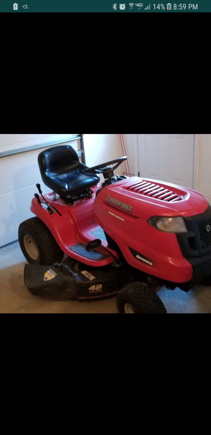 Troy Bilt Bronco riding lawn mower. May trade for newer electric/key start,self propelled lawnmower