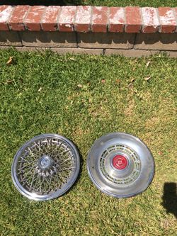 Hubcaps...one chevy and one caddy 14”