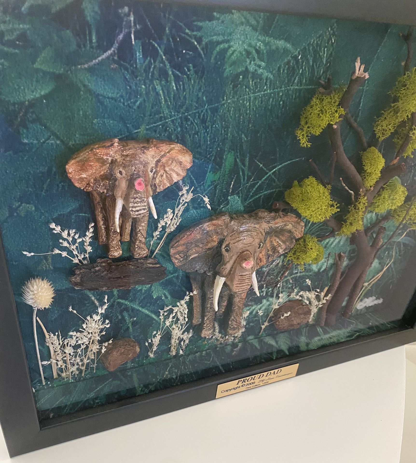 Very unique 1 of a kind 3-D effect beautiful hand sculpted and hand painted mother and baby elephant enclosed in a very expensive shadow box. Set in