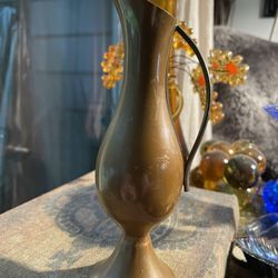Very old rustic vintage copper/ brass watering pitcher /vase with  handle and fantastic patina. with a flared base and pinched spout.Would look great 