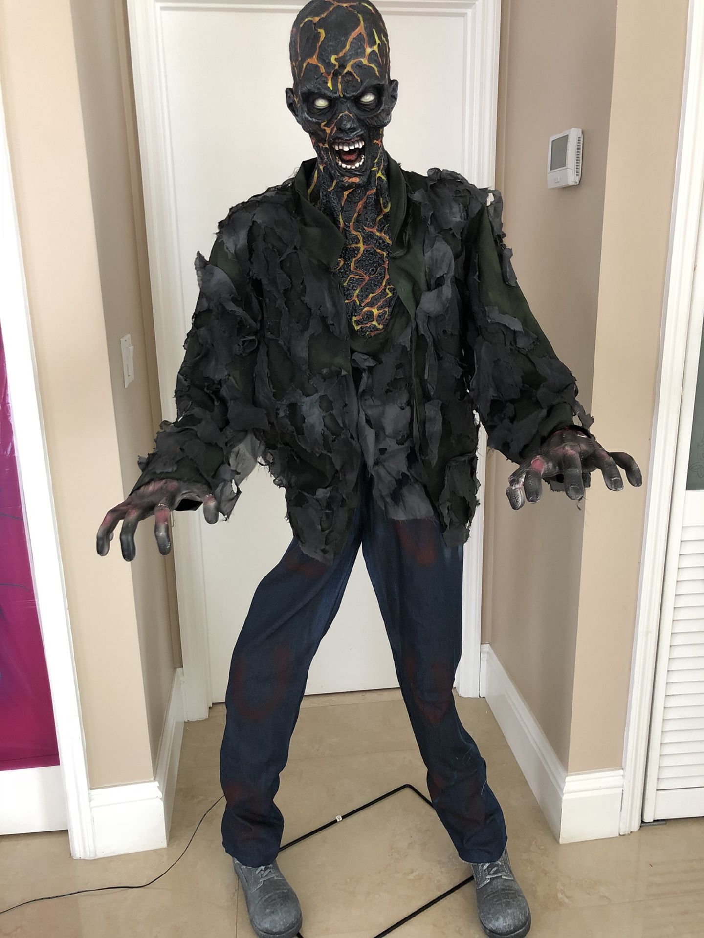 The animated 6FT Smoldering Zombie Lifesize halloween decoration