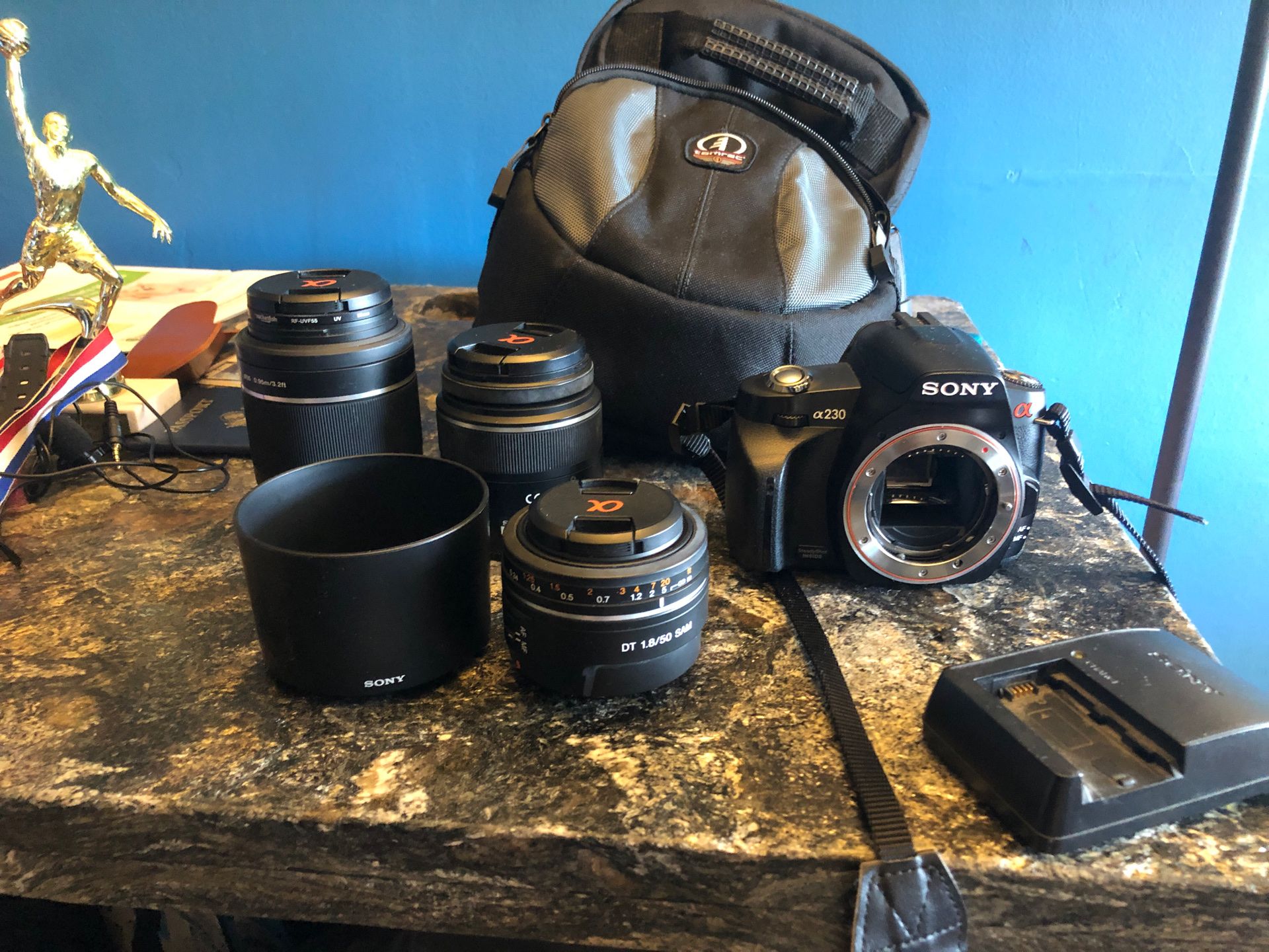 Sony A230 DSLR Camera with 3 lens, battery, charger, and camera bag